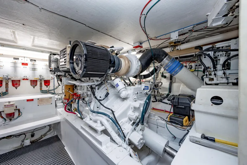 Slide: The Image of Engine room of 2000 Hatteras 50 Convertible yacht, showcasing mechanical components and wiring. - 36