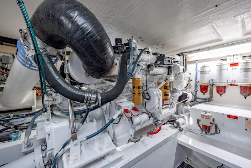 Slide: The Image of Engine room of 2000 Hatteras 50 Convertible yacht, featuring CAT machinery and components. - 39