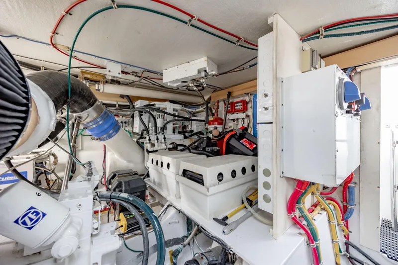 Slide: The Image of Engine room of 2000 Hatteras 50 Convertible yacht with complex wiring and machinery. - 42