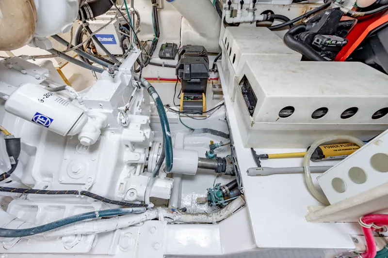 Slide: The Image of Engine room of 2000 Hatteras 50 Convertible yacht, showcasing mechanical components and systems. - 44