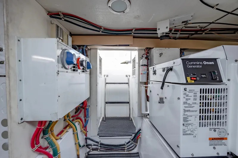 Slide: The Image of Engine room of 2000 Hatteras 50 Convertible with Cummins Onan generator and wiring. - 46