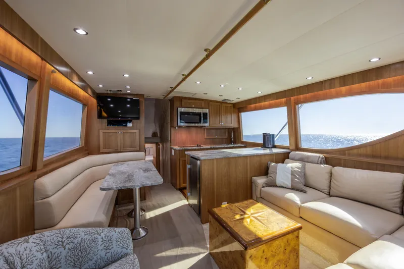 Slide: The Image of Luxurious interior of 2000 Hatteras 50 Convertible yacht with elegant seating and ocean view. - 47