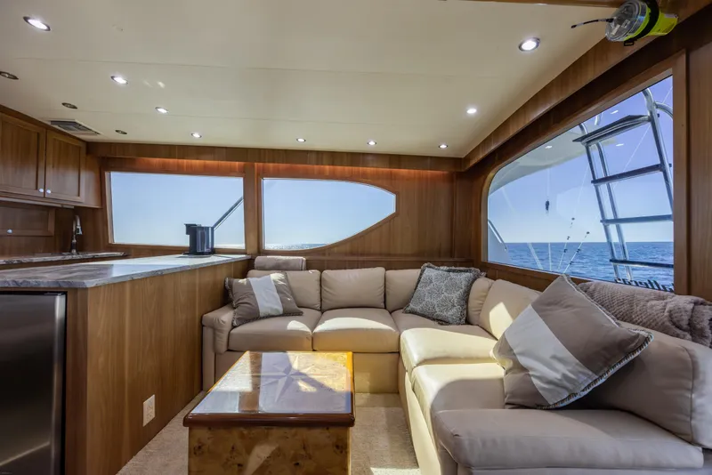 Slide: The Image of Luxurious interior of 2000 Hatteras 50 Convertible yacht with ocean view and plush seating. - 48