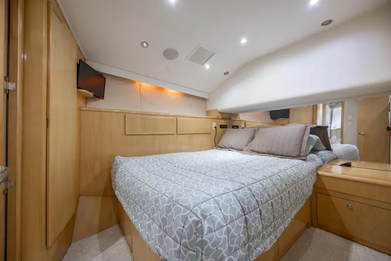 Slide: The Image of Luxurious bedroom interior of 2000 Hatteras 50 Convertible yacht with modern amenities. - 61