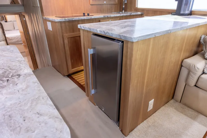 Slide: The Image of Interior of 2000 Hatteras 50 Convertible yacht with modern kitchen and seating area. - 53