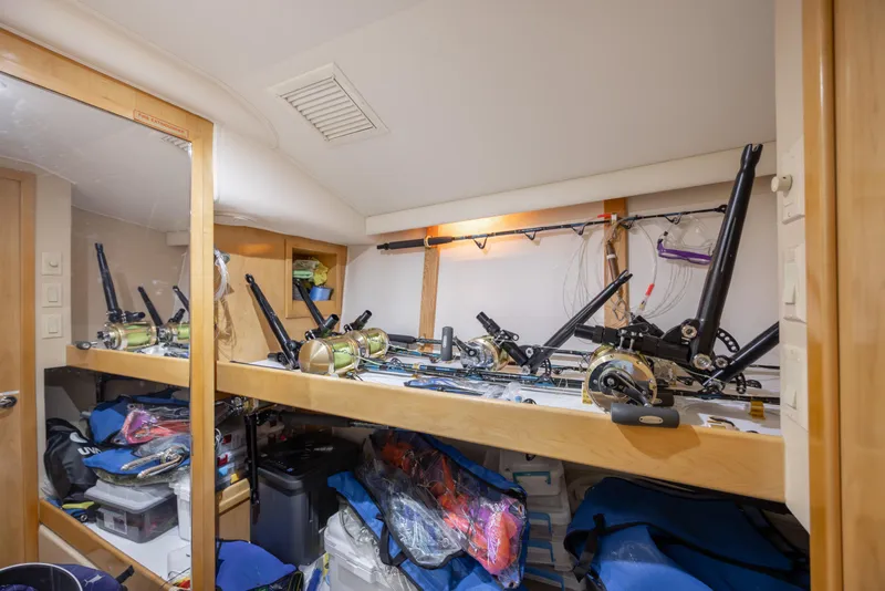 Slide: The Image of Storage area with fishing rods and gear on a 2000 Hatteras 50 Convertible yacht. - 58
