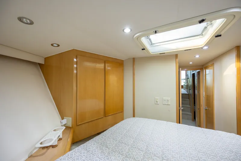 Slide: The Image of Interior of 2000 Hatteras 50 Convertible yacht bedroom with skylight and wooden cabinetry. - 70