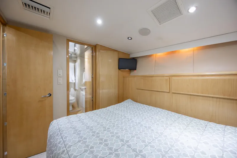 Slide: The Image of Interior of 2000 Hatteras 50 Convertible yacht bedroom with ensuite bathroom. - 62
