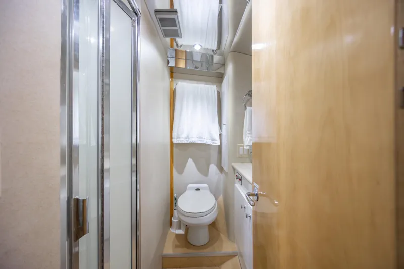 Slide: The Image of Bathroom interior of 2000 Hatteras 50 Convertible yacht, featuring shower and toilet. - 63