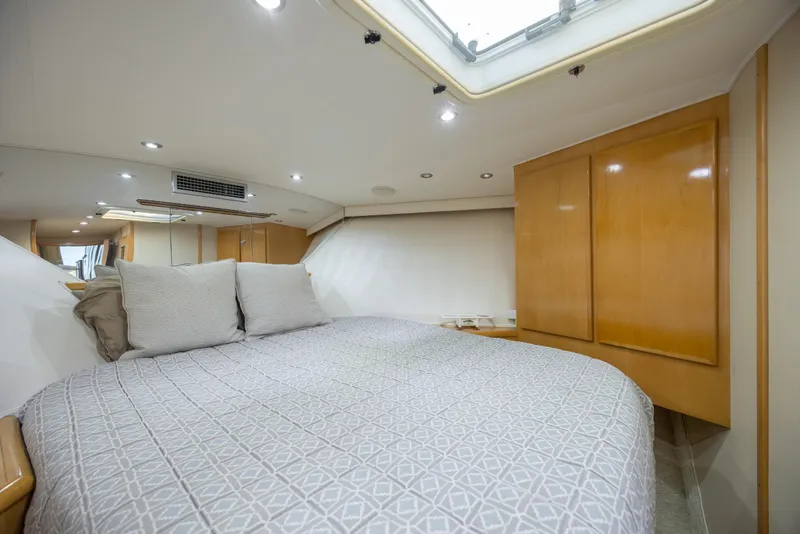 Slide: The Image of Luxurious bedroom interior of 2000 Hatteras 50 Convertible yacht with modern design. - 69
