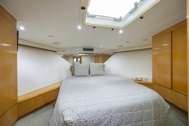 Slide: The Image of Luxurious bedroom interior of 2000 Hatteras 50 Convertible yacht with skylight and modern design. - 68