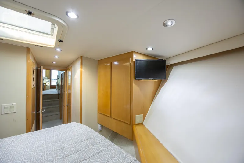 Slide: The Image of Interior of 2000 Hatteras 50 Convertible yacht bedroom with TV and modern lighting. - 72