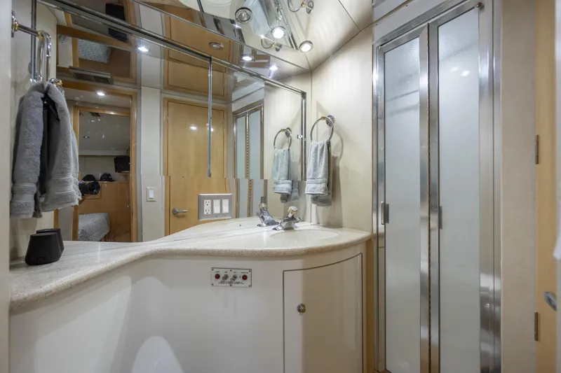 Slide: The Image of Luxurious bathroom in 2000 Hatteras 50 Convertible yacht with modern fixtures and frosted glass shower. - 73