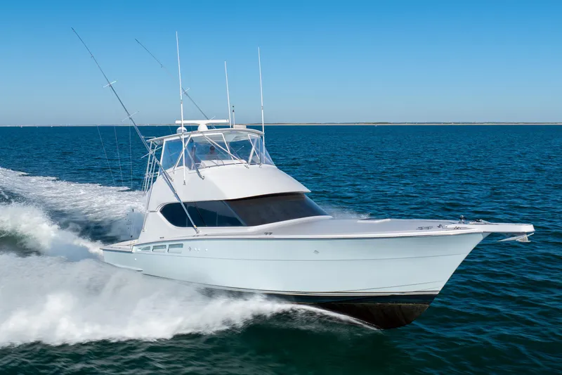 Slide: The Image of 2000 Hatteras 50 Convertible yacht cruising on open water. - 77