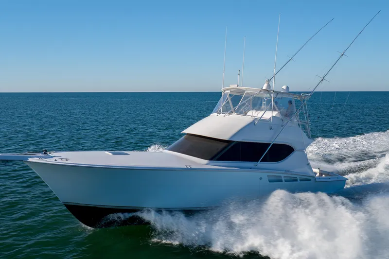 Slide: The Image of 2000 Hatteras 50 Convertible yacht cruising on open water. - 79