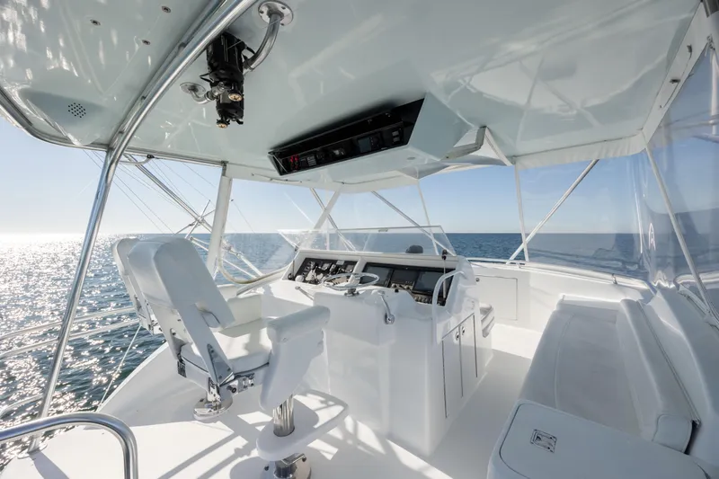 Slide: The Image of Helm of 2000 Hatteras 50 Convertible yacht with ocean view and modern controls. - 8