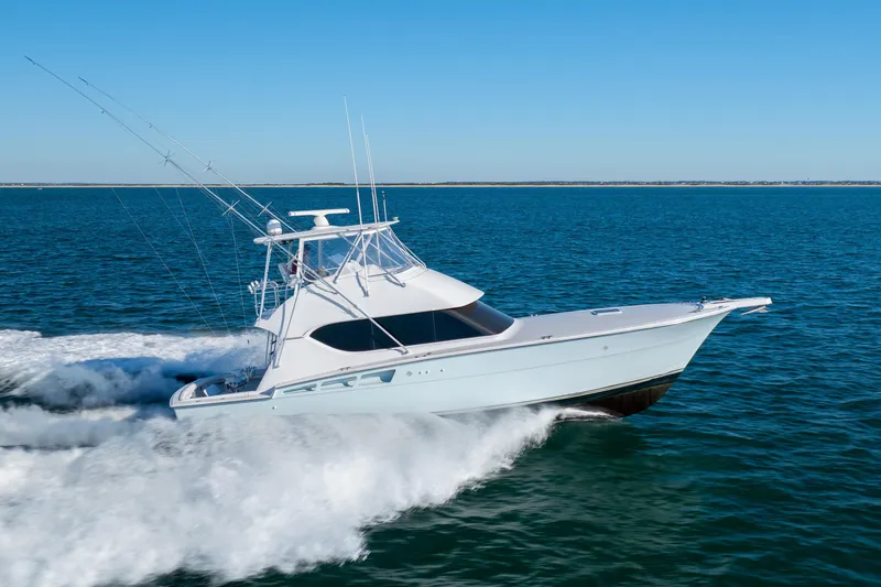 Slide: The Image of 2000 Hatteras 50 Convertible yacht cruising on open water. - 76
