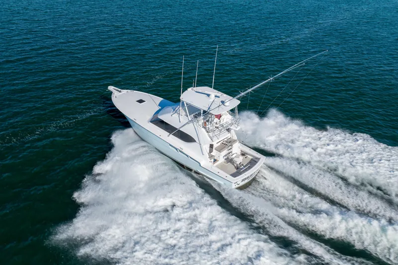 Slide: The Image of 2000 Hatteras 50 Convertible yacht cruising on open water, aerial view. - 83