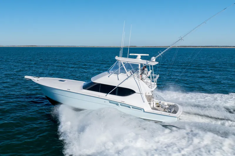 Slide: The Image of 2000 Hatteras 50 Convertible yacht cruising on open water. - 85
