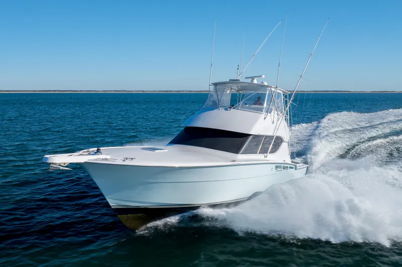 Slide: The Image of Hatteras 50 Convertible 2000 yacht cruising on open water, creating a dynamic wake. - 86
