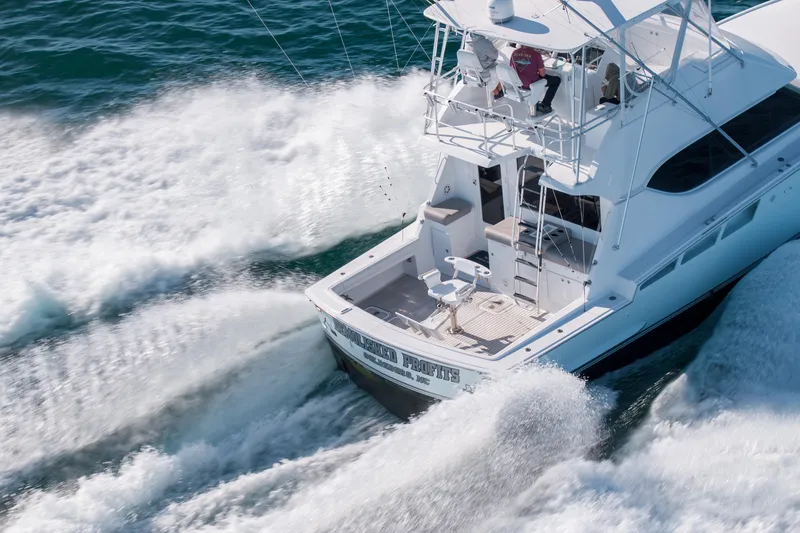 Slide: The Image of 2000 Hatteras 50 Convertible yacht cruising swiftly on open water. - 87