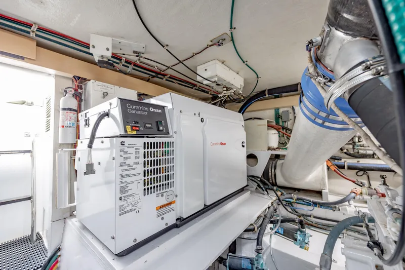 Slide: The Image of Engine room of 2000 Hatteras 50 Convertible with Cummins Onan generator. - 43