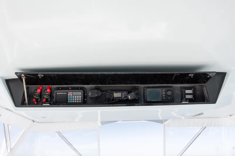 Slide: The Image of Control panel of 2000 Hatteras 50 Convertible yacht with communication and navigation equipment. - 12