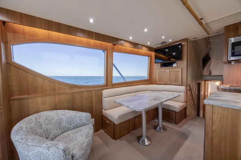 Slide: The Image of Luxurious interior of 2000 Hatteras 50 Convertible yacht with elegant seating and ocean view. - 52