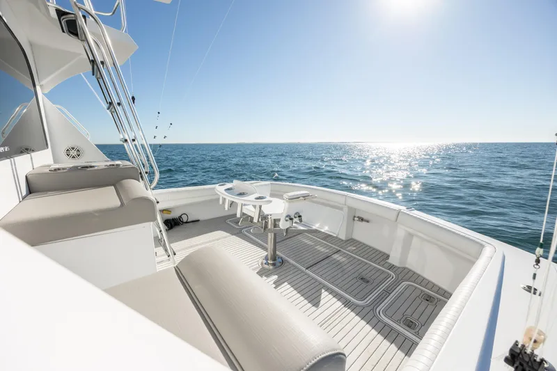 Slide: The Image of Hatteras 50 Convertible 2000 yacht deck with ocean view and bright sunlight. - 19
