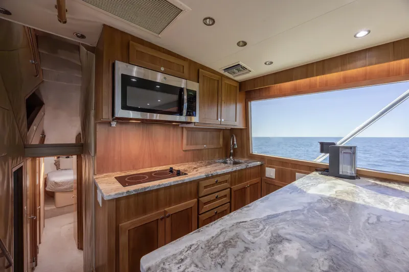 Slide: The Image of Luxurious kitchen interior of 2000 Hatteras 50 Convertible yacht with ocean view. - 54