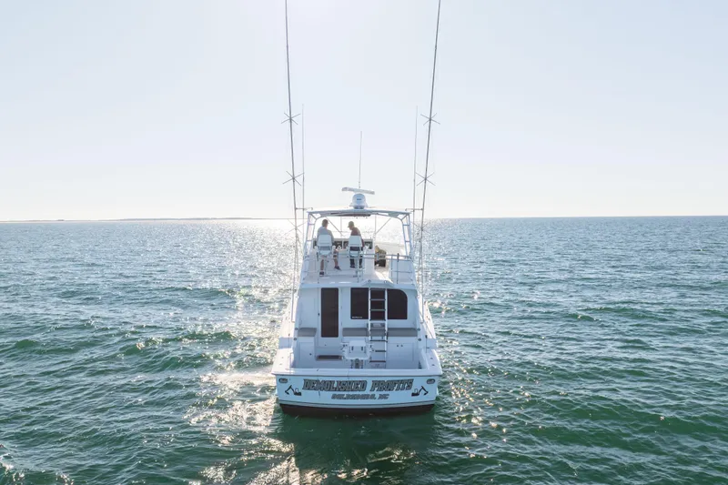 Slide: The Image of Hatteras 50 Convertible yacht cruising on open sea, 2000 model, rear view. - 6