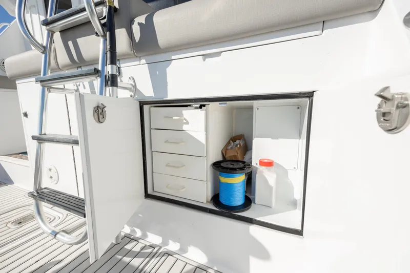 Slide: The Image of Storage compartment on 2000 Hatteras 50 Convertible yacht with ladder and equipment. - 27