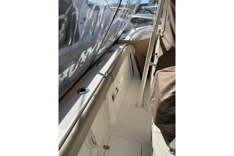 Slide: The Image of 2015 Pursuit C 280 Center Console boat interior with rod holders and seating. - 14