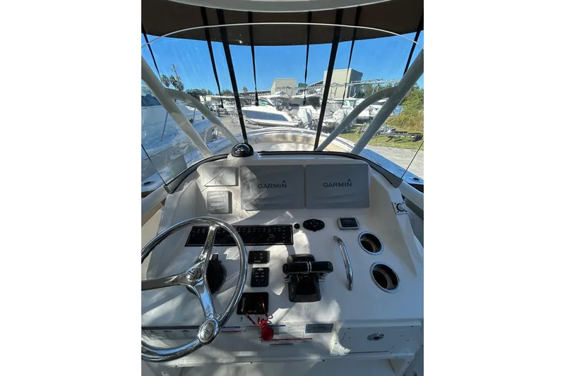Slide: The Image of 2015 Pursuit C 280 Center Console boat with dual engines and beige seating. - 3