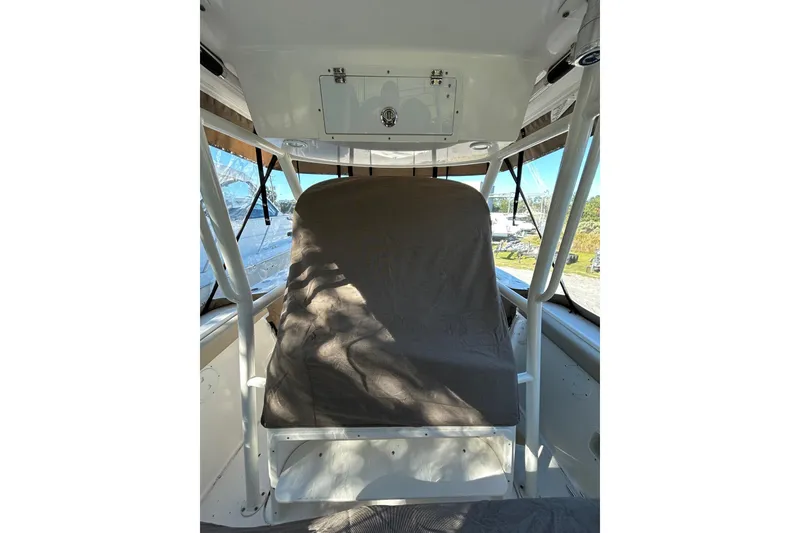 Slide: The Image of 2015 Pursuit C 280 Center Console boat with dual engines and beige seating. - 4
