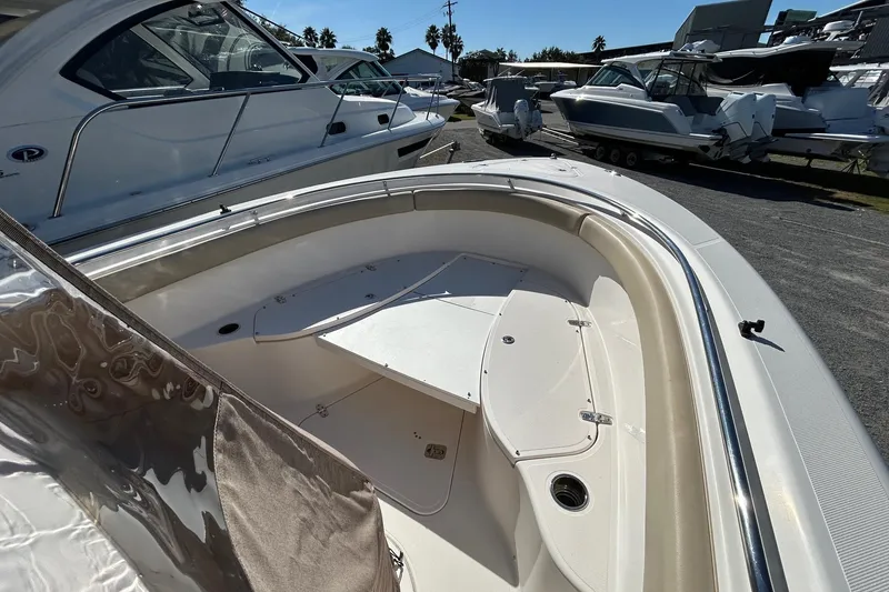 Slide: The Image of 2015 Pursuit C 280 Center Console boat, docked with other vessels in a marina. - 6