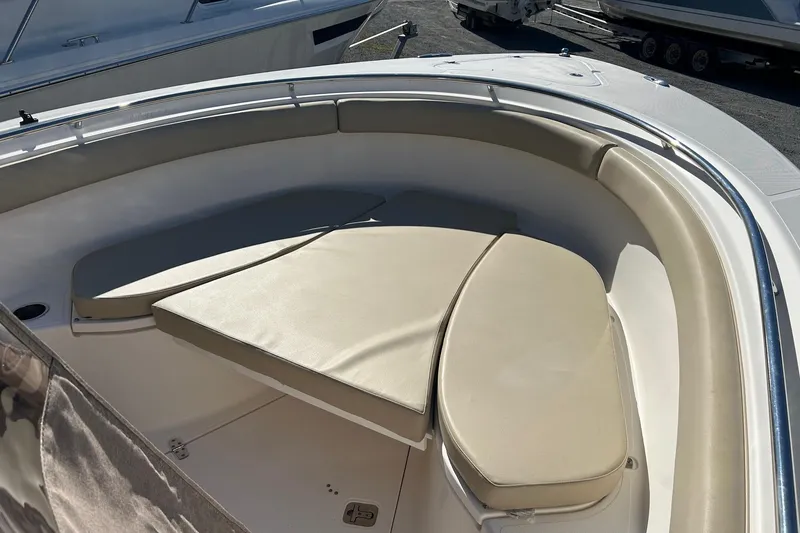 Slide: The Image of 2015 Pursuit C 280 Center Console boat with cushioned seating area. - 7