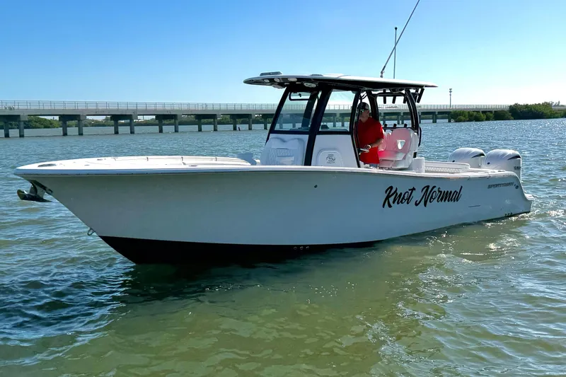 The Image of 2024 Sportsman Open 282TE Center Console boat on water, side view. - 0