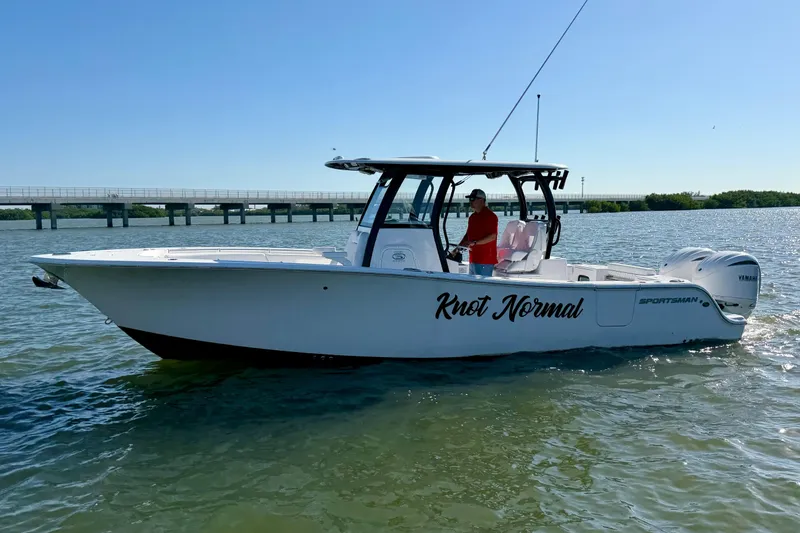 Slide: The Image of 2024 Sportsman Open 282TE Center Console boat on water, side view. - 1
