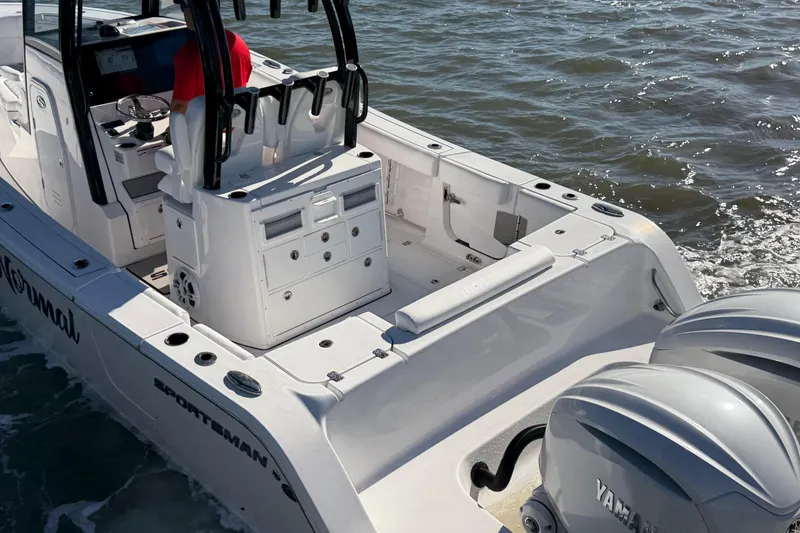Slide: The Image of 2024 Sportsman Open 282TE Center Console boat with dual Yamaha engines on water. - 10