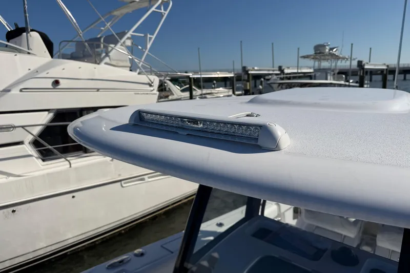 Slide: The Image of 2024 Sportsman Open 282TE Center Console boat with sleek design at marina. - 19