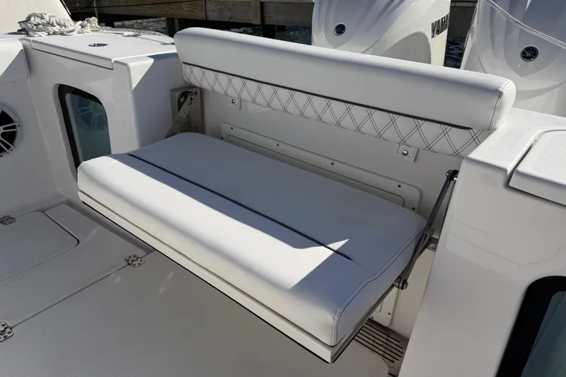 Slide: The Image of 2024 Sportsman Open 282TE Center Console boat with white cushioned seating. - 25