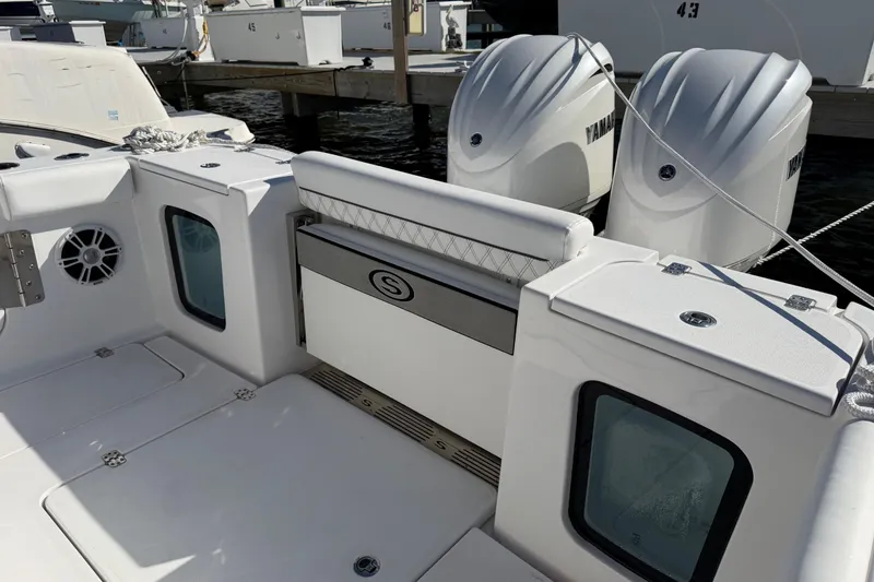Slide: The Image of 2024 Sportsman Open 282TE Center Console boat with dual Yamaha engines, docked. - 26