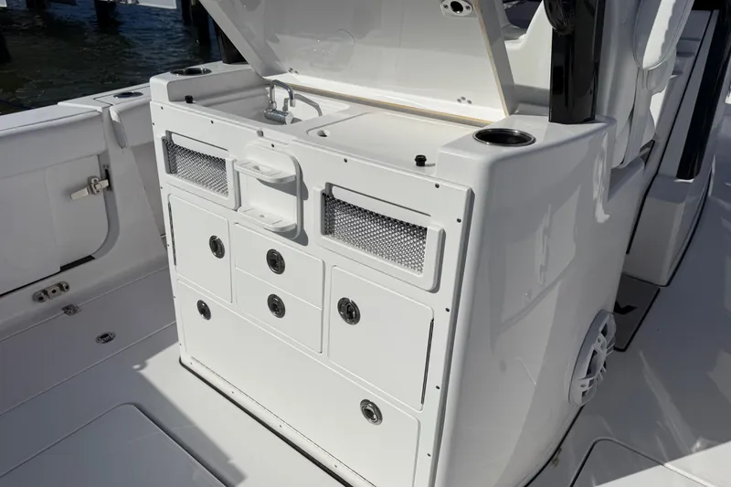 Slide: The Image of 2024 Sportsman Open 282TE Center Console with storage compartments and sink. - 27
