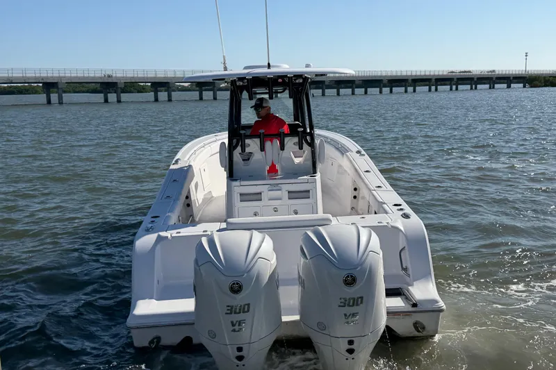 Slide: The Image of 2024 Sportsman Open 282TE Center Console boat on water, bridge in background. - 3