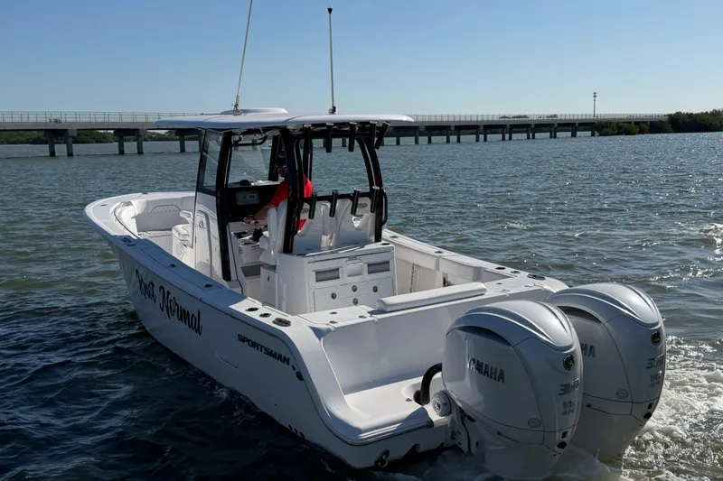 Slide: The Image of 2024 Sportsman Open 282TE Center Console boat cruising on a sunny day. - 4