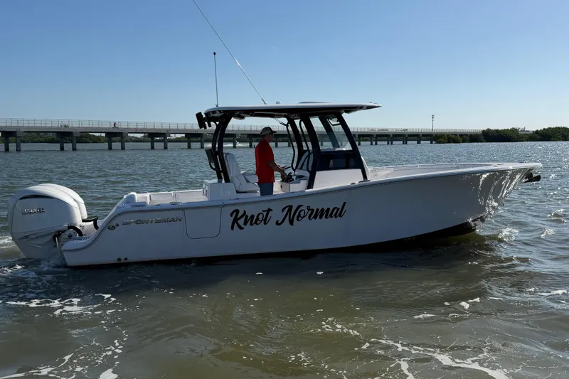 Slide: The Image of 2024 Sportsman Open 282TE Center Console boat on water, side view, with "Knot Normal" text. - 6
