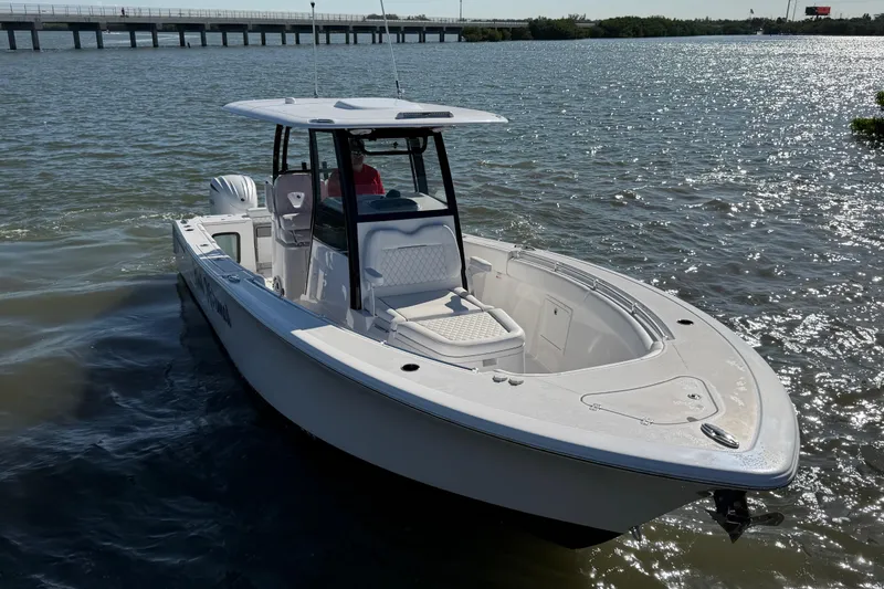 Slide: The Image of 2024 Sportsman Open 282TE Center Console boat on calm water. - 8