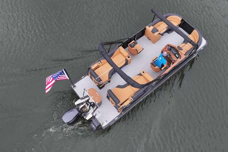 Slide: The Image of 2026 Avalon LSZ Quad Lounger Shift pontoon boat on water, American flag, aerial view. - 3