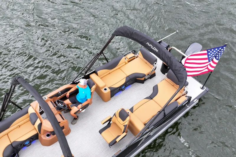Slide: The Image of 2026 Avalon LSZ Quad Lounger Shift pontoon boat on water with American flag. - 4